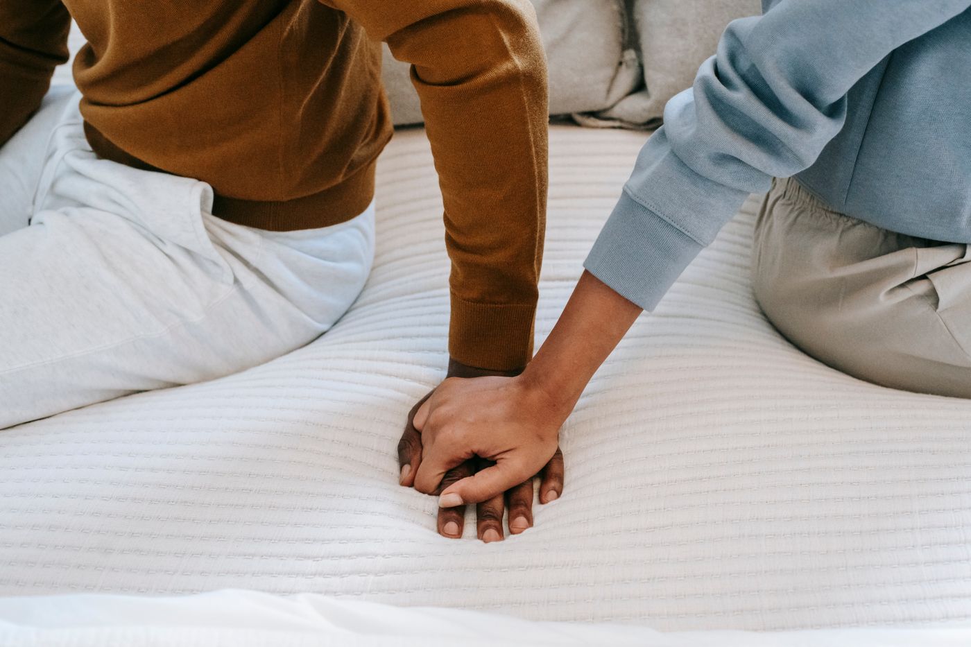 Two partners reaching to hold hands
